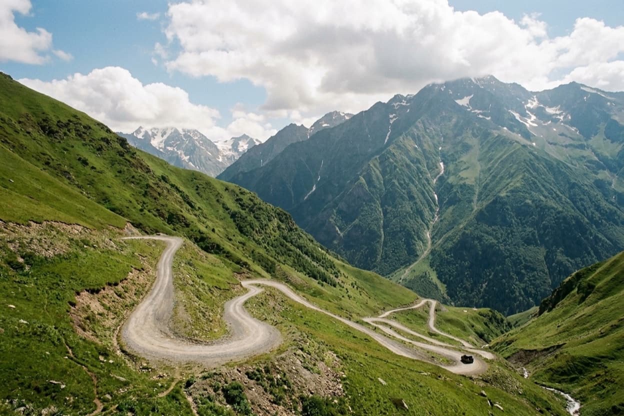 Gravel switchbacks of the Abano Pass road to Tusheti carved into a steep mountainside